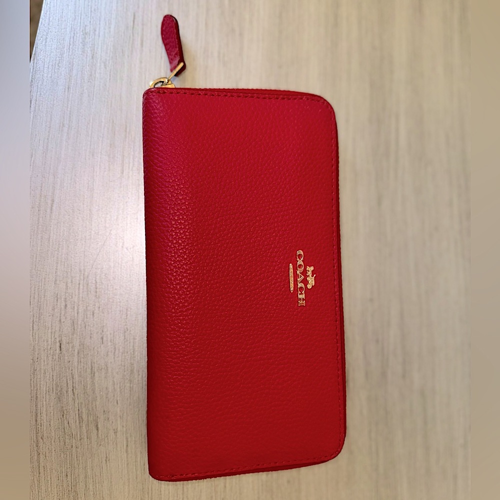 Red pebbled leather long zip coach wallet. Never used.